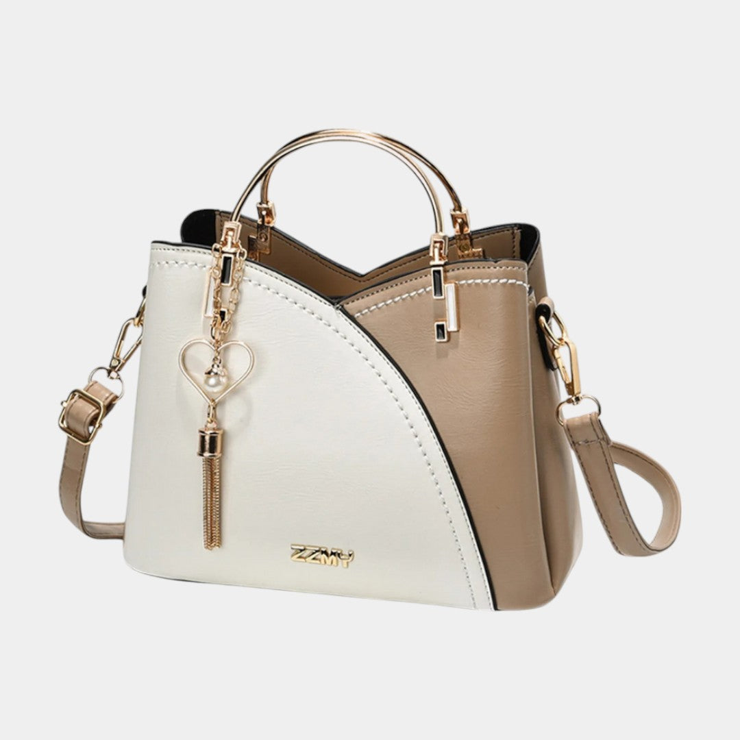 Women’s geometric leather handbag in medium size with removable strap, metal details, and multiple compartments for daily use
