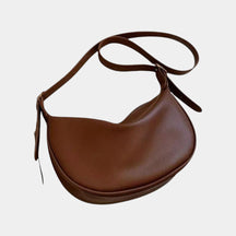 Women’s minimalist crossbody bag in soft PU leather, lightweight design with elegant shape, available in black, brown, and white